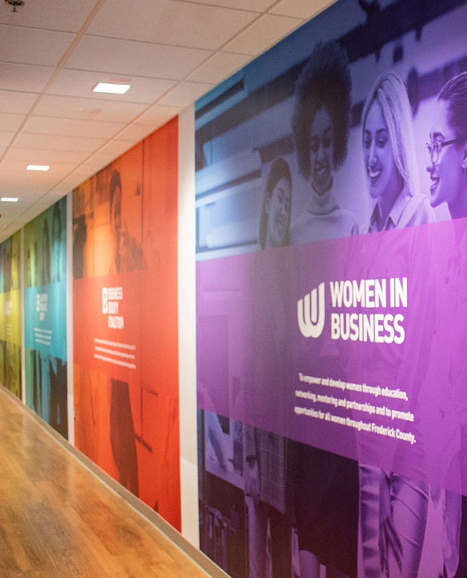 A branded interior space featuring custom wall graphics and architectural signage that reflects a business identity