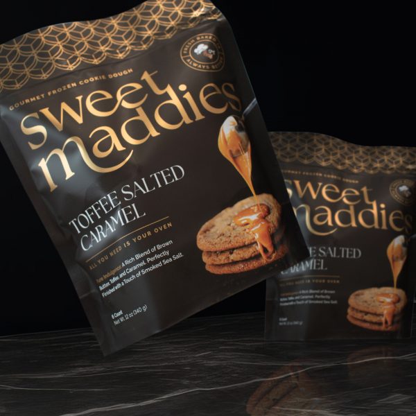 Sweet Maddies: Luxury cookie dough packaging design for Sweet Maddies featuring dark, elegant bags with gold foil typography.