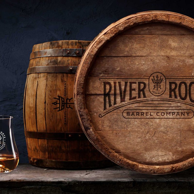 River Roots Barrel Company: Whiskey branding and rustic barrel-head label design for River Roots Barrel Company.